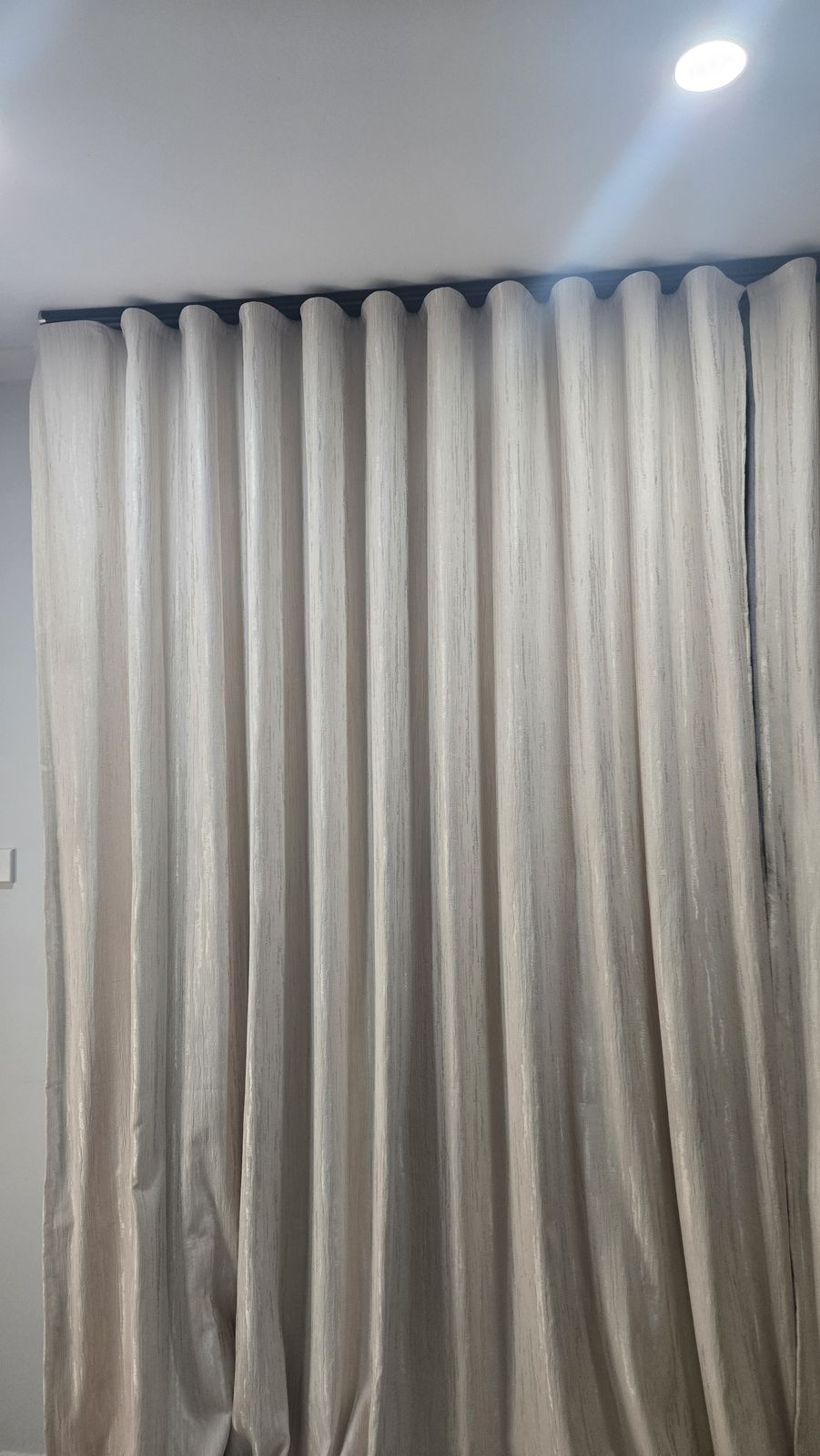 Wave fold curtains at dusk, evenly pleated