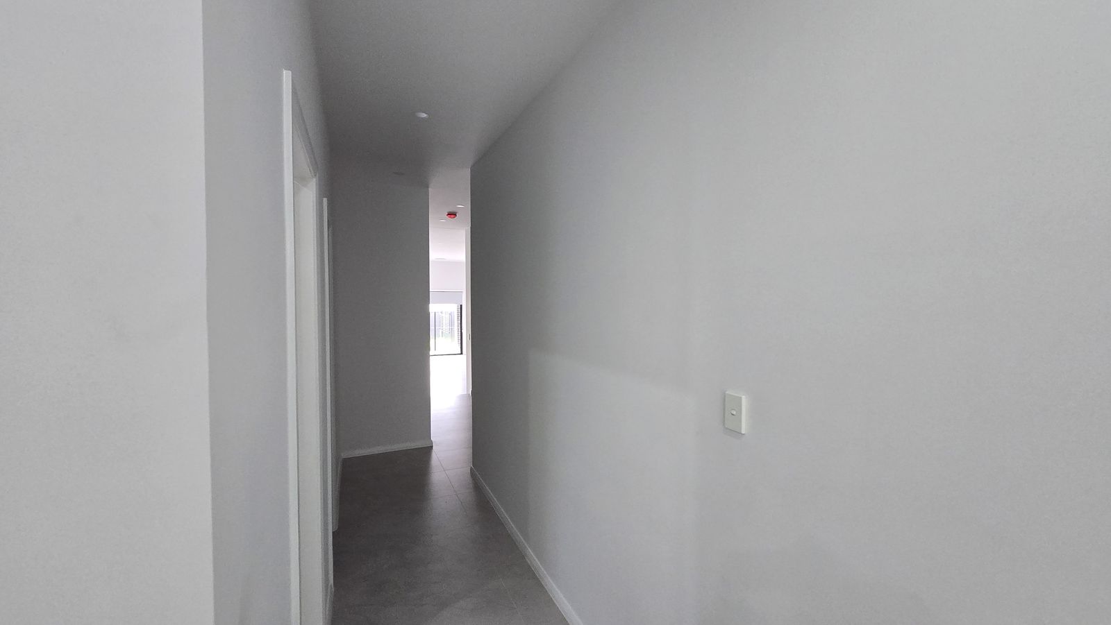 Before — the bare white hallway