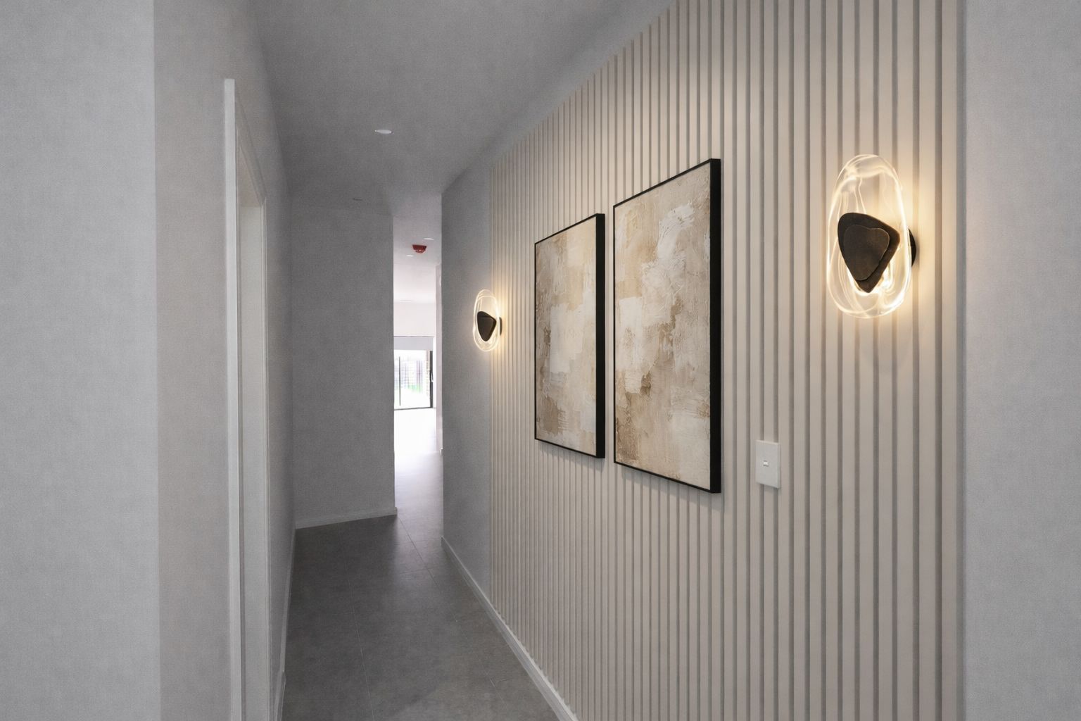 The vision — hallway with timber slat wall, brass sconces and framed art